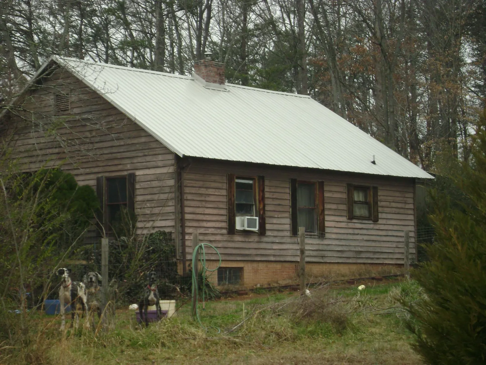 White metal roof on an old wood sided farmhouse, from a Metal Roof Installation job in Patterson